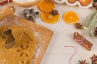 Raw dough for christmas cookies and cookie cutters on kitchen countertop [IBR124817924]