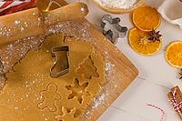 Raw dough for christmas cookies and cookie cutters on kitchen countertop [IBR124817926]