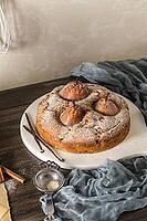 Delicious cake with pear, ginger and cinnamon on a dark kitchen counter [IBR124817928]