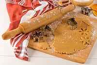 Raw dough for christmas cookies and cookie cutters on kitchen countertop [IBR124817930]