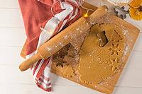 Raw dough for christmas cookies and cookie cutters on kitchen countertop [IBR124817932]