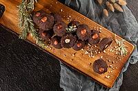 Dark chocolate truffles with hazelnuts over wooden cutting board [IBR124817934]