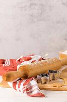 Raw dough for christmas cookies and cookie cutters on kitchen countertop [IBR124817937]
