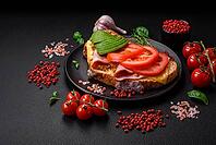 Food, Delicious nutritious grilled toast with ham, cheese, tomatoes and avocado with salt, spices and herbs on a dark concrete background [IBR124842017]