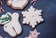 Food, Beautiful festive Christmas gingerbread made by hand with decoration elements on a dark concrete background [IBR124842034]