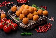 Food, Delicious fried potato balls with breaded mozzarella, salt, spices and herbs on a dark concrete background [IBR124842037]