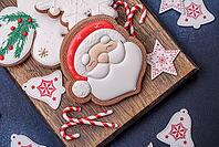 Food, Beautiful festive Christmas gingerbread made by hand with decoration elements on a dark concrete background [IBR124842042]