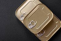 Food, Tin or aluminum rectangular can of canned food with a key on a dark concrete background [IBR124842043]