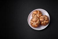 Food, Delicious freshly baked crispy bun or kaiser roll with sesame seeds on dark concrete background [IBR124842051]