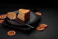 Food, Delicious fresh sweet honey cake layer cake with white cream on textured concrete background [IBR124842055]