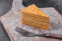 Food, Delicious fresh sweet honey cake layer cake with white cream on textured concrete background [IBR124842058]