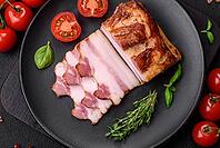 Food, Delicious calorie smoked bacon with salt, spices and herbs on a dark concrete background [IBR124842084]