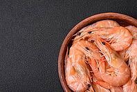 Food, Delicious fresh boiled tiger prawns with salt and spices on a ceramic plate on a dark concrete background [IBR124842091]