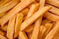 Food, Delicious crispy french fries with salt and spices in a cardboard box on a dark concrete background [IBR124842101]
