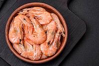 Food, Delicious fresh boiled tiger prawns with salt and spices on a ceramic plate on a dark concrete background [IBR124842105]