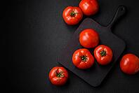 Food, Delicious fresh juicy tomatoes on a dark concrete background. Sauce Ingredients [IBR124842106]