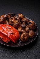 Grilled mushroom pieces, a vegetarian healthy meal with sauce. Barbecue mushroom halves as a food backdrop for your design [IBR124865237]