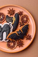 Halloween cookies, sweets, or gingerbread, a cat, a bat, and a hat. Halloween cookies as a backdrop for your design [IBR124865239]