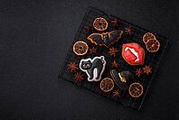 Halloween cookies, sweets, or gingerbread, a cat, a bat, and a hat. Halloween cookies as a backdrop for your design [IBR124865240]