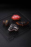 Halloween cookies, sweets, or gingerbread, a cat, a bat, and a hat. Halloween cookies as a backdrop for your design [IBR124865243]