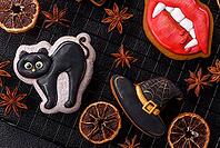 Halloween cookies, sweets, or gingerbread, a cat, a bat, and a hat. Halloween cookies as a backdrop for your design [IBR124865245]