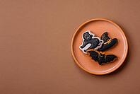 Halloween cookies, sweets, or gingerbread, a cat, a bat, and a hat. Halloween cookies as a backdrop for your design [IBR124865247]