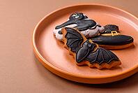 Halloween cookies, sweets, or gingerbread, a cat, a bat, and a hat. Halloween cookies as a backdrop for your design [IBR124865248]