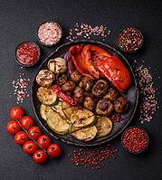 Grilled vegetables, bell peppers, mushrooms, and zucchini, a vegetarian healthy meal with sauce. Grilled vegetables on a plate as a food background for your design [IBR124865255]