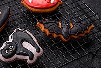 Halloween cookies, sweets, or gingerbread, a cat, a bat, and a hat. Halloween cookies as a backdrop for your design [IBR124865259]