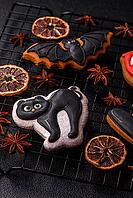 Halloween cookies, sweets, or gingerbread, a cat, a bat, and a hat. Halloween cookies as a backdrop for your design [IBR124865263]