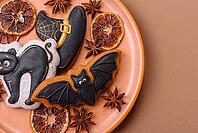 Halloween cookies, sweets, or gingerbread, a cat, a bat, and a hat. Halloween cookies as a backdrop for your design [IBR124865265]