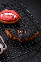 Halloween cookies, sweets, or gingerbread, a cat, a bat, and a hat. Halloween cookies as a backdrop for your design [IBR124865269]