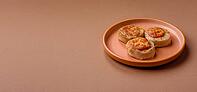 Round fish or chicken cutlets baked with tomato and cheese. Fish cutlets as a food backdrop for your design [IBR124865271]