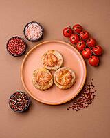 Round fish or chicken cutlets baked with tomato and cheese. Fish cutlets as a food backdrop for your design [IBR124865272]
