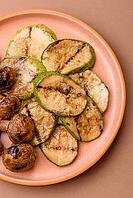 Grilled green zucchini slices, vegetarian food. Green barbecue zucchini as a food background for your design [IBR124865278]