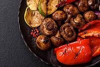 Grilled vegetables, bell peppers, mushrooms, and zucchini, a vegetarian healthy meal with sauce. Grilled vegetables on a plate as a food background for your design [IBR124865282]