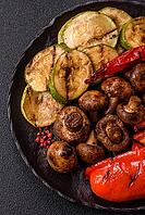 Grilled vegetables, bell peppers, mushrooms, and zucchini, a vegetarian healthy meal with sauce. Grilled vegetables on a plate as a food background for your design [IBR124865283]