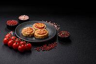 Round fish or chicken cutlets baked with tomato and cheese. Fish cutlets as a food backdrop for your design [IBR124865296]