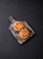 Round fish or chicken cutlets baked with tomato and cheese. Fish cutlets as a food backdrop for your design [IBR124865297]