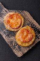Round fish or chicken cutlets baked with tomato and cheese. Fish cutlets as a food backdrop for your design [IBR124865298]