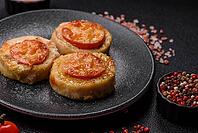 Round fish or chicken cutlets baked with tomato and cheese. Fish cutlets as a food backdrop for your design [IBR124865299]