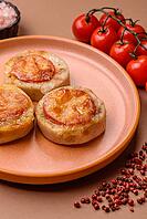 Round fish or chicken cutlets baked with tomato and cheese. Fish cutlets as a food backdrop for your design [IBR124865300]