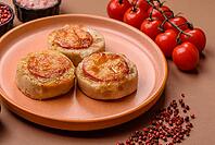 Round fish or chicken cutlets baked with tomato and cheese. Fish cutlets as a food backdrop for your design [IBR124865307]