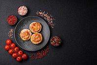 Round fish or chicken cutlets baked with tomato and cheese. Fish cutlets as a food backdrop for your design [IBR124865308]