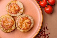Round fish or chicken cutlets baked with tomato and cheese. Fish cutlets as a food backdrop for your design [IBR124865311]