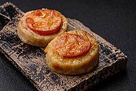 Round fish or chicken cutlets baked with tomato and cheese. Fish cutlets as a food backdrop for your design [IBR124865313]