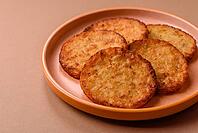 Potato hash browns, a cooked vegetable breakfast food. Potato hash browns as a food background for your design [IBR124865315]