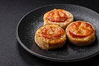 Round fish or chicken cutlets baked with tomato and cheese. Fish cutlets as a food backdrop for your design [IBR124865317]