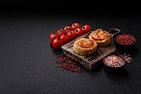 Round fish or chicken cutlets baked with tomato and cheese. Fish cutlets as a food backdrop for your design [IBR124865319]