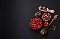 Food, Composition, concept, consisting of several types of different colors of allspice in bowls and spoons on a dark concrete background [IBR124876414]